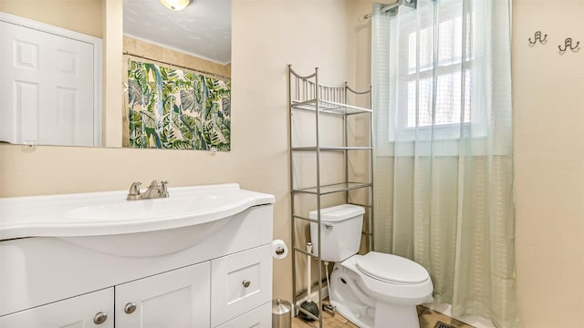 bathroom with tile patterned floors, toilet, vanity, and a shower with curtain