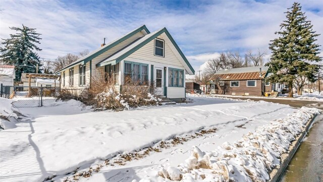 694 Russell St, Craig, CO 81625 - snow covered house featuring fence