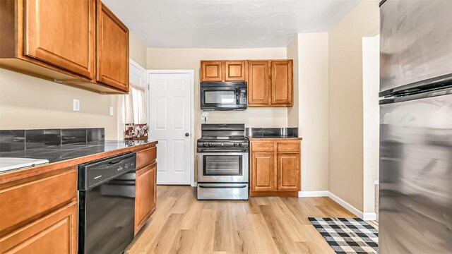 694 Russell St, Craig, CO 81625 - kitchen featuring light wood-type flooring, brown cabinets, and black appliances