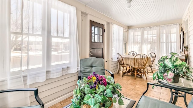 sunroom / solarium with tile patterned floors