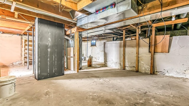 unfinished below grade area featuring heating unit