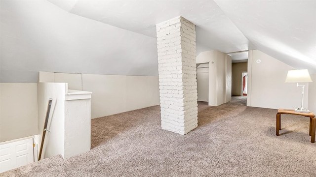 bonus room featuring lofted ceiling and carpet