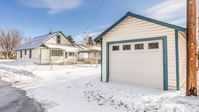 snow covered garage featuring a garage