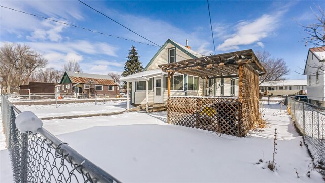 694 Russell St, Craig, CO 81625 - snow covered property featuring a pergola, entry steps, and fence