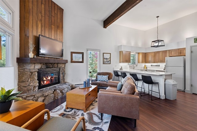 100 N Gold Flake Ter Unit A, Breckenridge, CO 80424 - living area featuring a high ceiling, a fireplace, dark wood-type flooring, beam ceiling, and a baseboard radiator