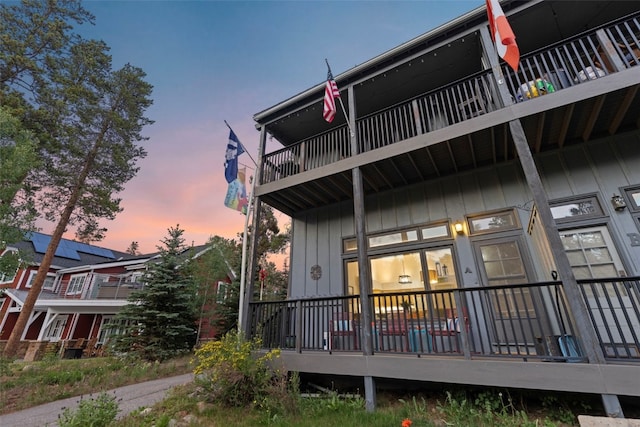 100 N Gold Flake Ter Unit A, Breckenridge, CO 80424 - back of house at dusk featuring a balcony and board and batten siding