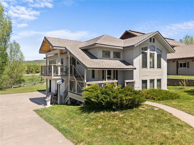 27358 Brandon Cir, Steamboat Springs, CO 80487 - view of front of house featuring stucco siding, concrete driveway, a front yard, a shingled roof, and an attached garage