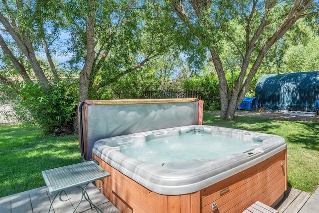 27125 Moonlight Way, Steamboat Springs, CO 80487 - wooden deck featuring a hot tub and a lawn