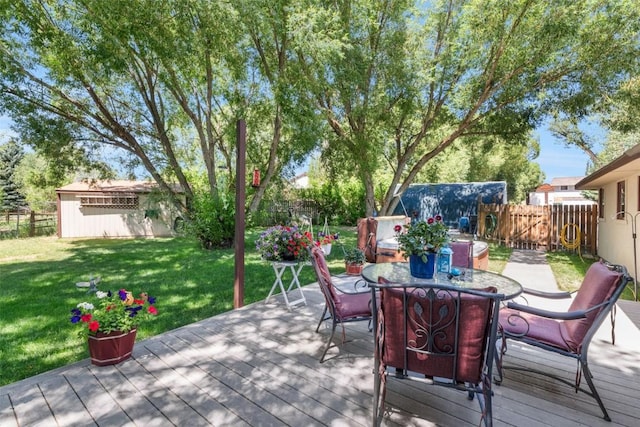 27125 Moonlight Way, Steamboat Springs, CO 80487 - wooden deck featuring a fenced backyard, an outbuilding, and outdoor dining space