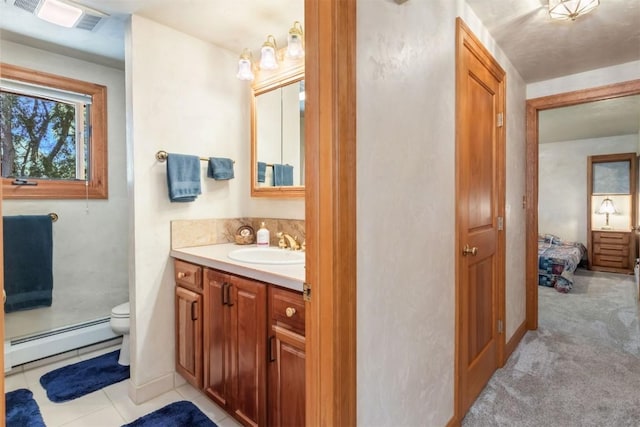 27125 Moonlight Way, Steamboat Springs, CO 80487 - bathroom featuring baseboard heating, vanity, connected bathroom, and tile patterned flooring