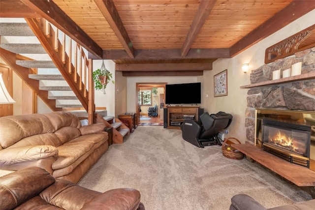 27125 Moonlight Way, Steamboat Springs, CO 80487 - living area with carpet flooring, a stone fireplace, stairway, and a wood ceiling with exposed beams