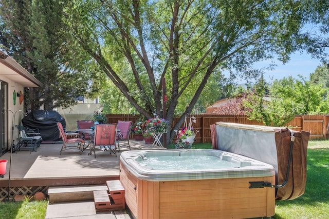 27125 Moonlight Way, Steamboat Springs, CO 80487 - wooden terrace with a hot tub, a fenced backyard, outdoor dining space, and grilling area