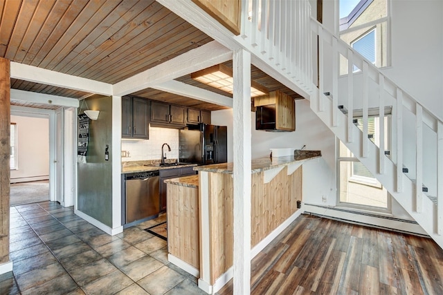 7031 Ryan Gulch Rd Unit 301, Silverthorne, CO 80498 - kitchen featuring stainless steel dishwasher, black fridge, a baseboard heating unit, a peninsula, and healthy amount of natural light