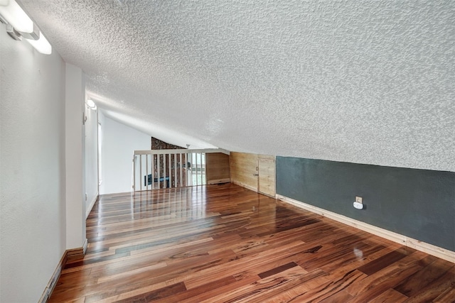 7031 Ryan Gulch Rd Unit 301, Silverthorne, CO 80498 - bonus room with a textured ceiling, wood finished floors, and vaulted ceiling