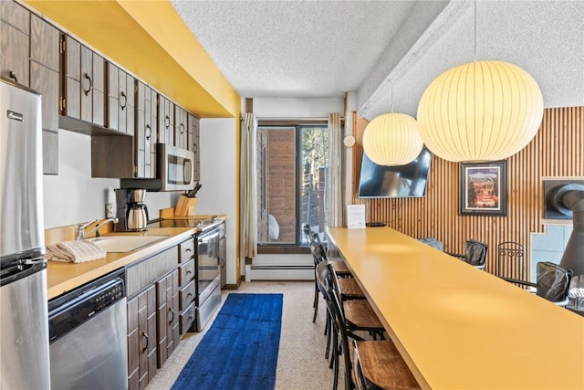 1140 Ski Hill Rd Unit 25, Breckenridge, CO 80424 - kitchen featuring stainless steel appliances, a sink, baseboard heating, a textured ceiling, and carpet floors