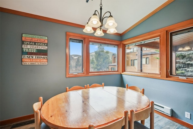 530 Tennis Club Rd Unit 1328, Keystone, CO 80435 - dining room featuring wood finished floors, baseboards, a baseboard heating unit, a notable chandelier, and lofted ceiling