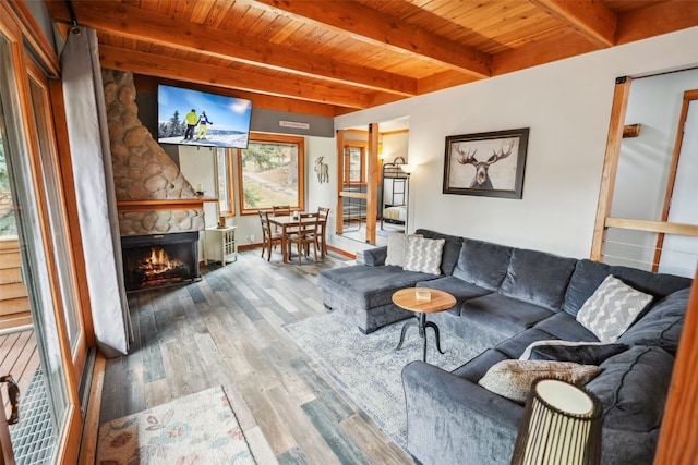 530 Tennis Club Rd Unit 1328, Keystone, CO 80435 - living area featuring a fireplace, wood finished floors, wooden ceiling, and beamed ceiling