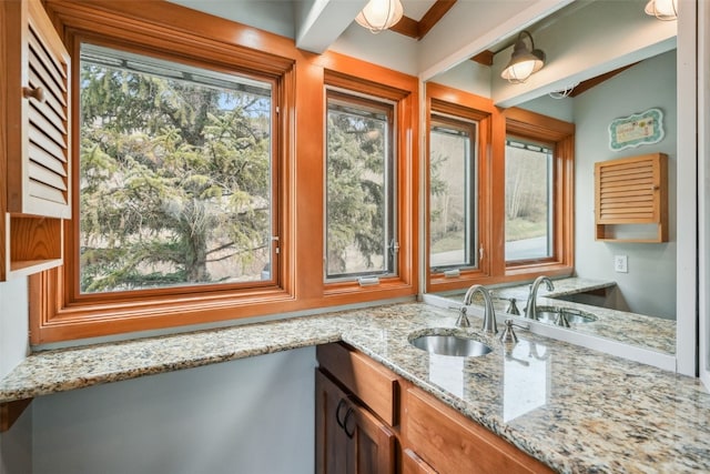 530 Tennis Club Rd Unit 1328, Keystone, CO 80435 - kitchen with brown cabinets, light stone counters, and a sink
