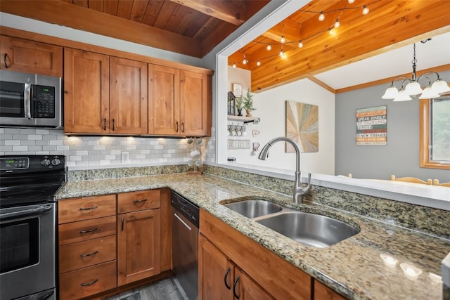 530 Tennis Club Rd Unit 1328, Keystone, CO 80435 - kitchen with appliances with stainless steel finishes, a sink, a chandelier, brown cabinetry, and decorative backsplash