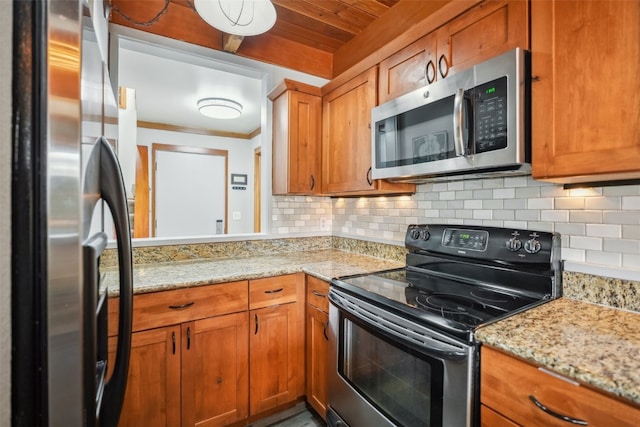 530 Tennis Club Rd Unit 1328, Keystone, CO 80435 - kitchen with appliances with stainless steel finishes, brown cabinetry, backsplash, and light stone counters