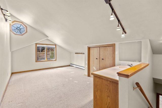 142 High Meadow Dr, Dillon, CO 80435 - bonus room featuring a baseboard heating unit, a sink, carpet, lofted ceiling, and baseboards