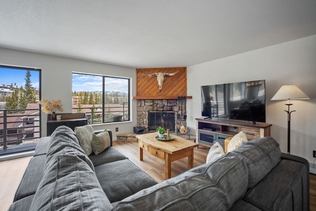 9876 Ryan Gulch Rd Unit 206, Silverthorne, CO 80498 - living area featuring wood finished floors and a fireplace