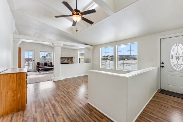 370 Stone Creek Dr, Fairplay, CO 80440 - foyer entrance featuring a stone fireplace, a ceiling fan, decorative columns, and wood finished floors