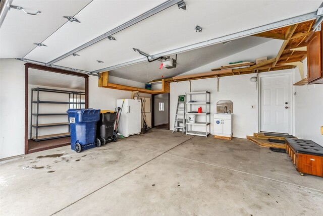 370 Stone Creek Dr, Fairplay, CO 80440 - garage featuring a garage door opener and freestanding refrigerator