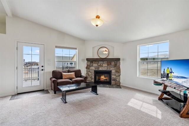 370 Stone Creek Dr, Fairplay, CO 80440 - carpeted living room featuring baseboards, a fireplace, beam ceiling, and a wealth of natural light