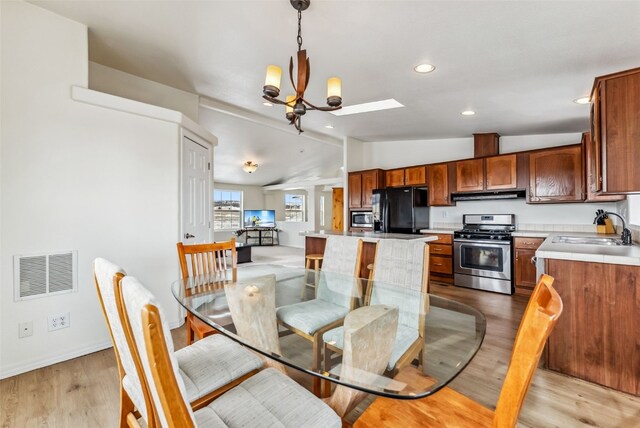370 Stone Creek Dr, Fairplay, CO 80440 - dining space featuring a notable chandelier, recessed lighting, baseboards, lofted ceiling, and visible vents