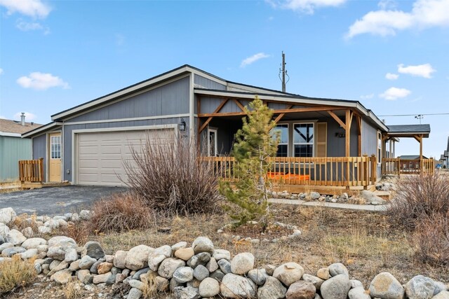 370 Stone Creek Dr, Fairplay, CO 80440 - view of front facade featuring covered porch, aphalt driveway, and a garage