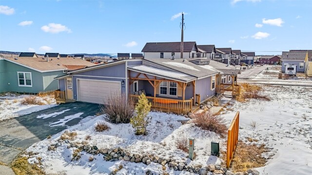370 Stone Creek Dr, Fairplay, CO 80440 - view of front of property featuring a porch, a garage, aphalt driveway, and a residential view