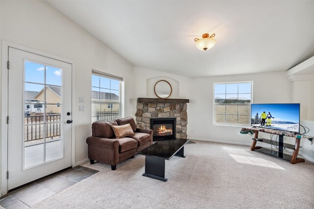 370 Stone Creek Dr, Fairplay, CO 80440 - living room with baseboards, carpet flooring, a stone fireplace, and a wealth of natural light