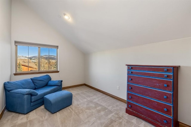 living area with lofted ceiling, carpet flooring, and baseboards