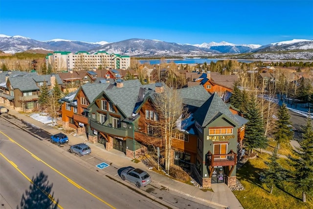 drone / aerial view featuring a water and mountain view