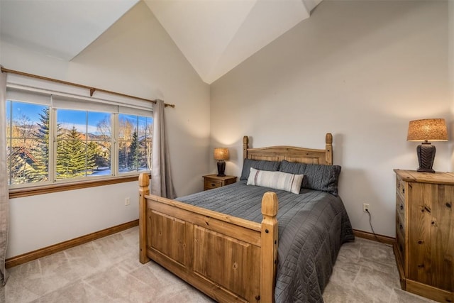 bedroom with light colored carpet, baseboards, and vaulted ceiling