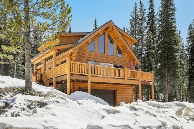 282 Sally Cir, Breckenridge, CO 80424 - view of front facade featuring log exterior, a wooden deck, and a garage