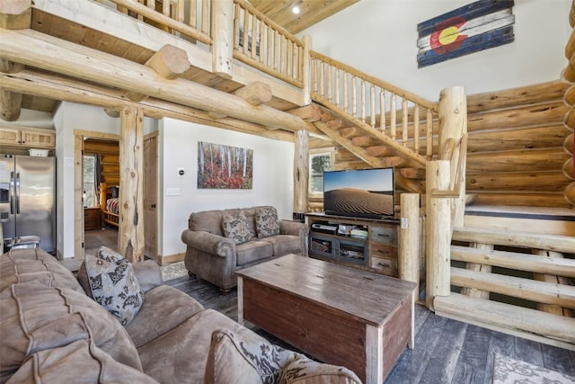282 Sally Cir, Breckenridge, CO 80424 - living room featuring rustic walls, dark wood-type flooring, a high ceiling, and stairs