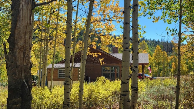 27100 Beaver Canyon Dr, Clark, CO 80428 - view of side of property with a wooded view and roof with shingles