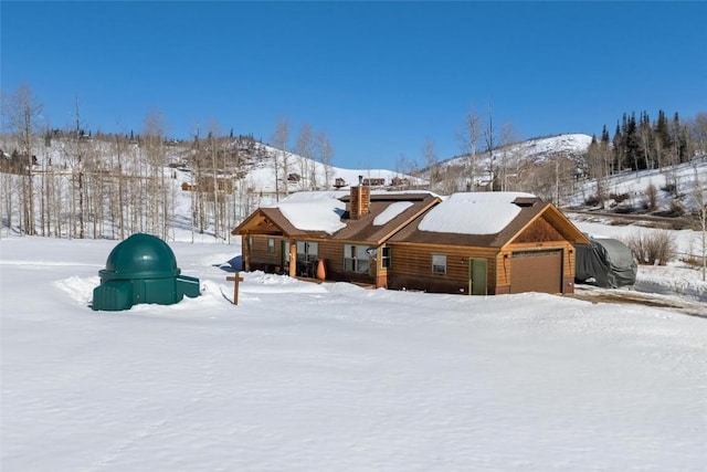 27100 Beaver Canyon Dr, Clark, CO 80428 - view of front of house featuring a chimney and an attached garage