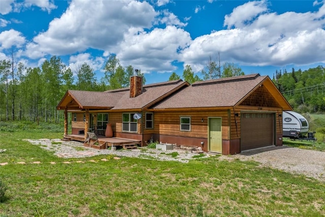 27100 Beaver Canyon Dr, Clark, CO 80428 - back of property with a chimney, a lawn, roof with shingles, and driveway