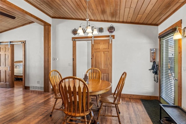 27100 Beaver Canyon Dr, Clark, CO 80428 - dining room featuring a barn door, crown molding, hardwood / wood-style floors, wood ceiling, and baseboards