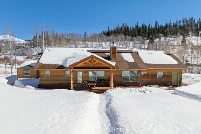 27100 Beaver Canyon Dr, Clark, CO 80428 - snow covered property with a chimney and a deck