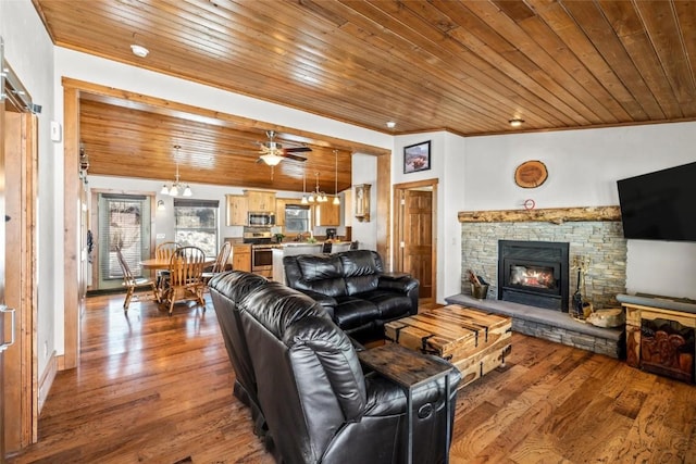27100 Beaver Canyon Dr, Clark, CO 80428 - living room with wood ceiling, a stone fireplace, hardwood / wood-style floors, crown molding, and a ceiling fan