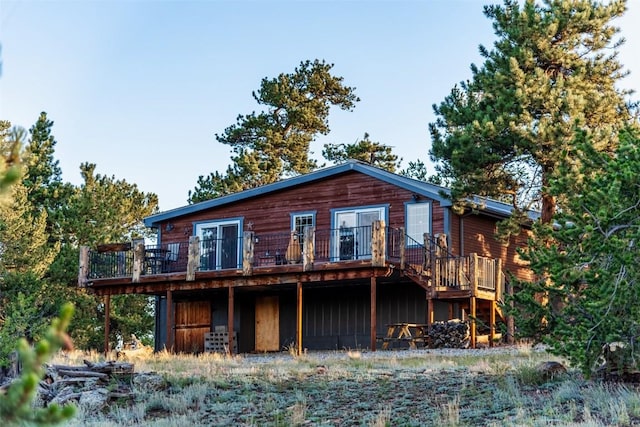 back of property with a wooden deck