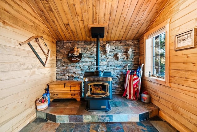 room details featuring wood ceiling, wooden walls, and a wood stove