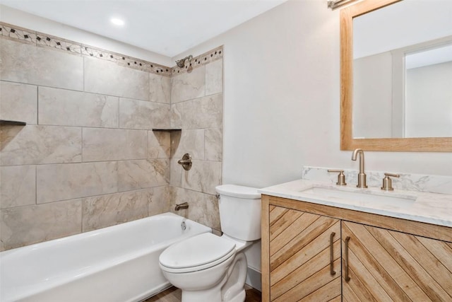 bathroom featuring toilet, vanity, and bathing tub / shower combination