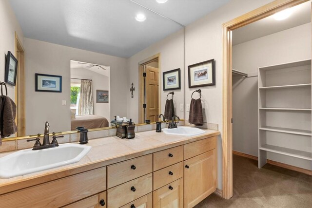 1506 Cascade Dr Unit 4, Steamboat Springs, CO 80487 - bathroom with double vanity, a closet, ensuite bath, and baseboards