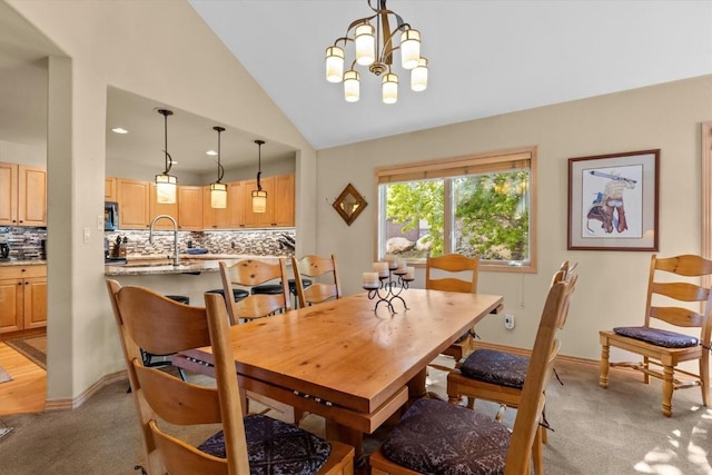 1506 Cascade Dr Unit 4, Steamboat Springs, CO 80487 - dining room with light carpet, lofted ceiling, a chandelier, and baseboards