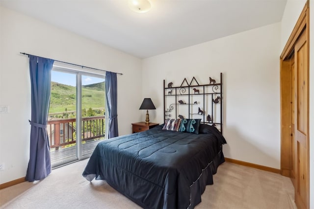 129 Lookout Ridge Dr Unit 129, Dillon, CO 80435 - bedroom featuring light carpet and access to exterior